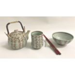 CHINESE TEA POT with a swing cane handle, matching tea bowl and bowl, all decorated with a grey wash