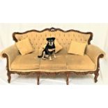 CONTINENTAL STYLE MAHOGANY THREE SEAT SOFA with a carved top rail above a button back and scroll