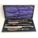 EDWARDIAN DOUBLE CARVING SET with a sharpening steel, all with antler handles and marked '