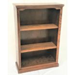 OAK OPEN FRONTED BOOKCASE with a moulded top above a shaped frieze with adjustable shelves below,