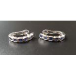 PAIR OF SAPPHIRE HALF HOOP EARRINGS each earring set with six bezel set princess cut sapphires, in