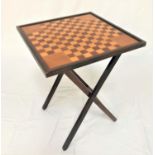 MAHOGANY AND ELM GAMES TABLE with a checker board top on a folding X frame, 68.5cm high