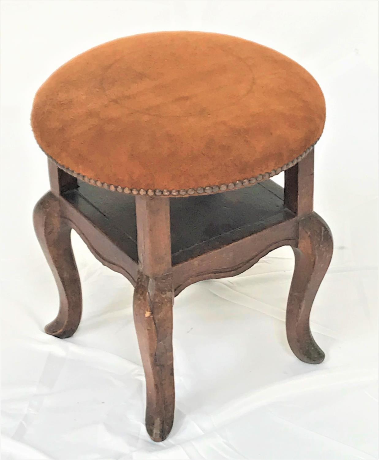 ELM CIRCULAR STOOL with a stuffover suede seat with decorative stud detail and an open shelf