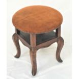 ELM CIRCULAR STOOL with a stuffover suede seat with decorative stud detail and an open shelf