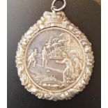 VICTORIAN WHITE METAL CURLING MEDAL one side relief decorated with figures curling, the other