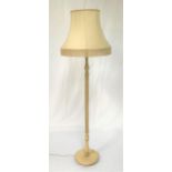 WOODEN PAINTED STANDARD LAMP raised on a circular base with a turned column and a shaped shade,
