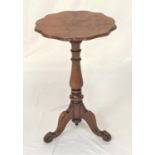 WALNUT TRIPOD WINE TABLE with a burr wavy rim top on a turned column with three outswept supports,