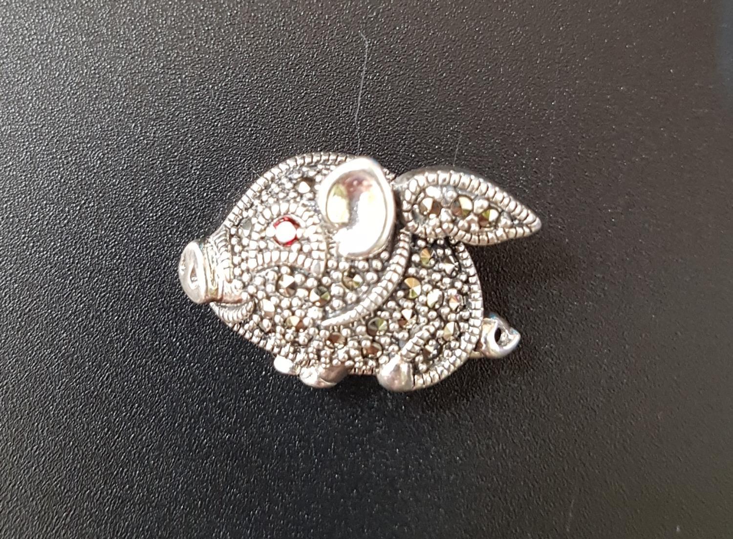 MARCASITE AND RUBY DECORATED SILVER FLYING PIG BROOCH/ PENDANT with ruby eye and marcasites overall,