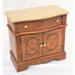 OAK BOW FRONT SIDE CABINET with a shaped marble top above a single drawer with a pair of carved