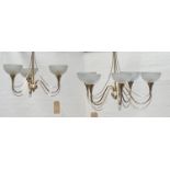 TWO BRASS CHANDELIERS both with suspension chains and glass shades, one with five shaped arms, the