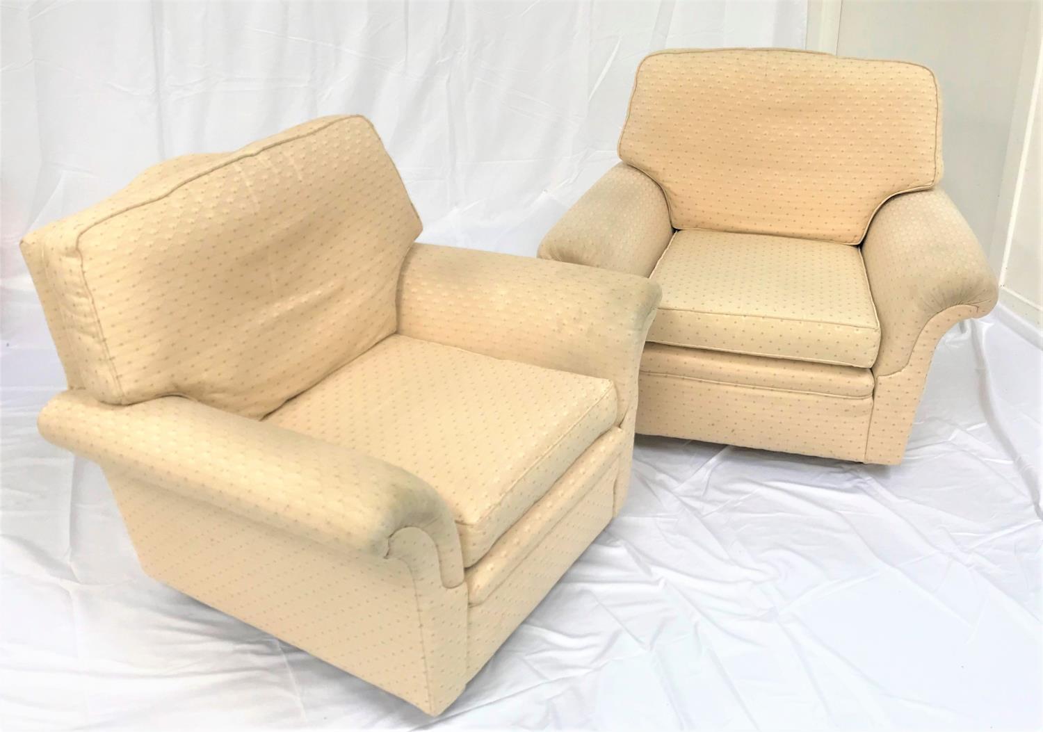 PAIR OF ARMCHAIRS each with a shaped back and scroll arms, with a loose seat and back cushion,