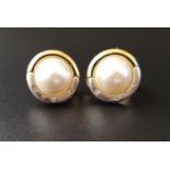 PAIR OF MABE PEARL AND DIAMOND EARRINGS the central pearl on each in two tone nine carat gold mount,