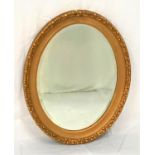 OVAL GILTWOOD MIRROR with a decorative frame and bevelled plate, 73cm high