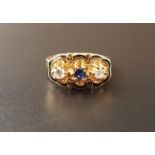 UNUSUAL SAPPHIRE AND DIAMOND THREE STONE RING the central sapphire flanked by round brilliant cut