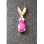 RUBY AND DIAMOND PENDANT the pear cut ruby approximately 0.4cts below three small diamonds, in
