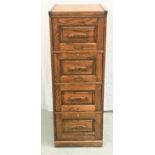 OAK OFFICE FILING CABINET of narrow proportions with four panelled deep drawers with carved handles,