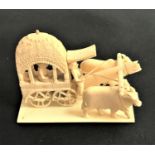 EARLY 20TH CENTURY INDIAN IVORY GROUP depicting two oxen pulling a cart, 9.5cm long