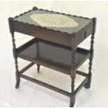 OAK HOSTESS TROLLEY with a wavy rim galleried top above an inset glass panel with a single frieze