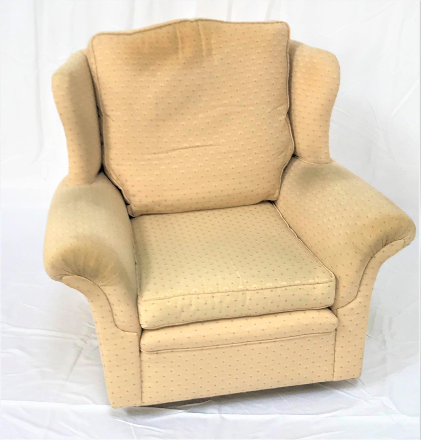 WING BACK ARMCHAIR with a shaped back and scroll padded arms, with loose seat and back cushion