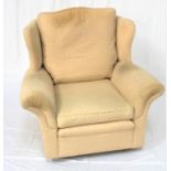 WING BACK ARMCHAIR with a shaped back and scroll padded arms, with loose seat and back cushion