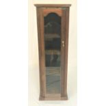 OAK DISPLAY CABINET of narrow proportions, with a moulded top above an arched glass door opening