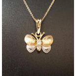 CZ SET TEN CARAT GOLD BUTTERFLY BROOCH PENDANT in two tone gold, on ten carat gold chain,