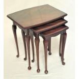 NEST OF MAHOGANY TABLES with a shaped inset top above a carved frieze, standing on slender