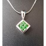 TSAVORITE GARNET PENDANT the nine gemstones totaling approximately 0.53cts in rhomboid shaped