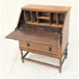 OAK BUREAU with a moulded top above a panelled fall flap opening to reveal a fitted interior above
