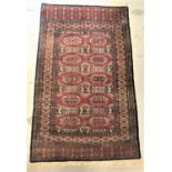 ISHFAN STYLE RUG the red and blue ground with central lozenge motifs encased by a decorative border,