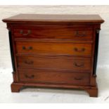 TEAK CHEST OF DRAWERS with a moulded top above four long drawers flanked by columns, standing on
