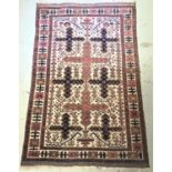MIDDLE EASTER RUG with a cream ground bearing navy blue and mushroom coloured crosses, 202cm x 130cm