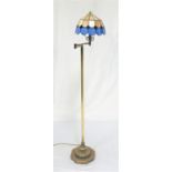 ADJUSTABLE BRASS STANDARD LAMP raised on an octagonal base and tubular column to a two section