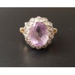 AMETHYST AND DIAMOND CLUSTER DRESS RING the central oval cut amethyst in illusion set diamond