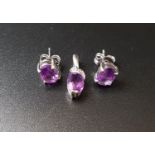 MATCHED SUITE OF AMETHYST JEWELLERY comprising a pair of oval cut amethyst stud earrings, the