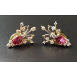 PAIR OF UNUSUAL RUBY AND DIAMOND EARRINGS the central oval cut ruby on each approxmately 0.75cts,
