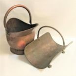 COPPER HELMET COAL SCUTTLE with a swing handle together with a dished copper log basket with swing