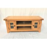 LIGHT OAK LOW TELEVISION CABINET with an oblong top above two central open shelves flanked by a pair