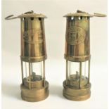 TWO WELSH MINERS LAMPS with brass bodies and suspension hooks with glass lower section, each with
