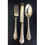 HIGHLY DECORATIVE VICTORIAN SILVER GILT KNIFE, FORK AND SPOON, all with raised foliate decoration to