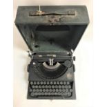 PORTABLE IMPERIAL TYPEWRITER in a hard shell case with carry handle