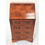 YEW WOOD BUREAU with an inlaid flap opening to reveal an inset leather and a fitted interior above