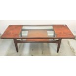 G PLAN TEAK OCCASIONAL TABLE with an inset glass panel top above a shelf, standing on tapering