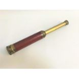 FOUR DRAW BRASS TELESCOPE with a mahogany covered lens section