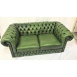 CHESTERFIELD TWO SEAT SOFA in green leather with button back and arms with decorative metal stud