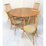 ERCOL LIGHT OAK CIRCULAR DINING SUITE the table with drop flaps, standing on beech gate legs,