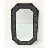 OCTAGONAL WALL MIRROR with a brass embossed frame decorated with shells around a bevelled plate,