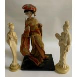 VINTAGE MODEL OF A GEISHA with porcelain head, hands and foot, raised on wooden stand, 32.8cm