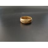 EIGHTEEN CARAT GOLD BAND with linear engraved decoration, ring size W and approximately 8.2 grams