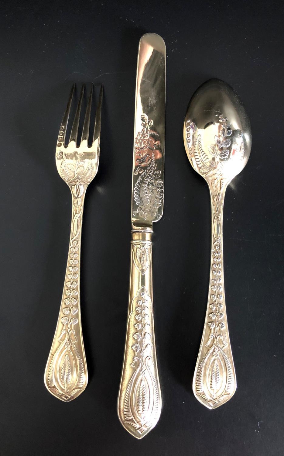 HIGHLY DECORATIVE VICTORIAN SILVER GILT KNIFE, FORK AND SPOON, all with raised foliate decoration to - Image 2 of 2